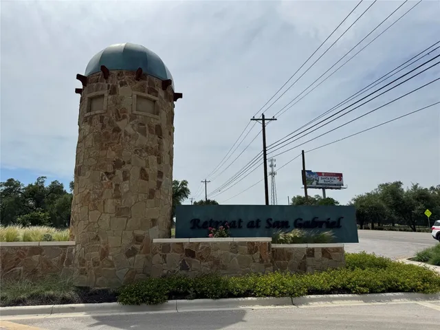 a kitchen with kitchen island granite countertop a sink a counter top space appliances and cabinets