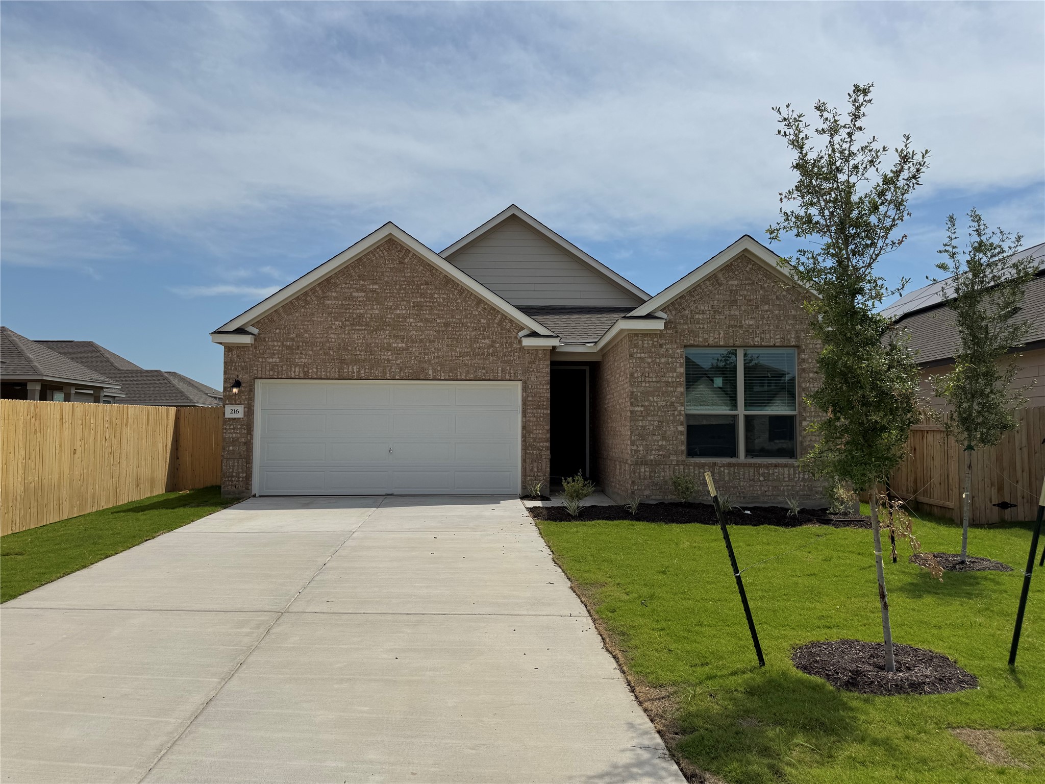 216 Coastal Way Georgetown, TX 78628 - Photo 6 of 38 a front view of a house with a yard and garage