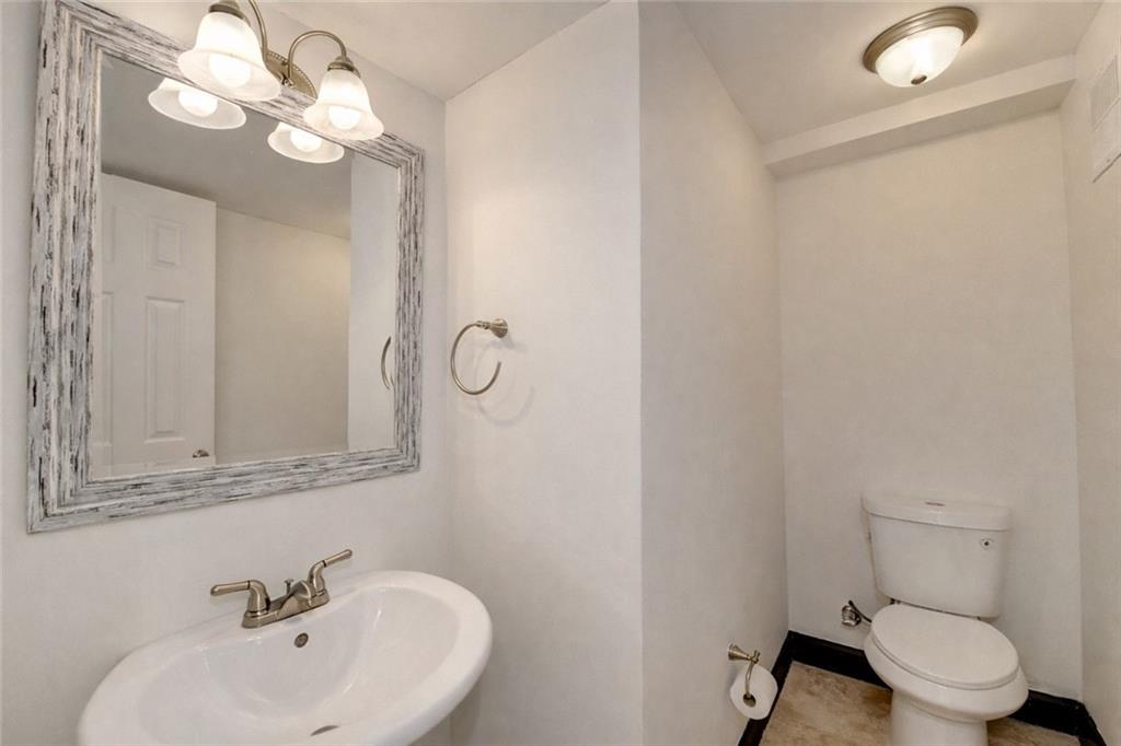 6980 Roswell Road, Unit C5 Atlanta, GA 30328 - Photo 11 of 22 a bathroom with a toilet sink and mirror