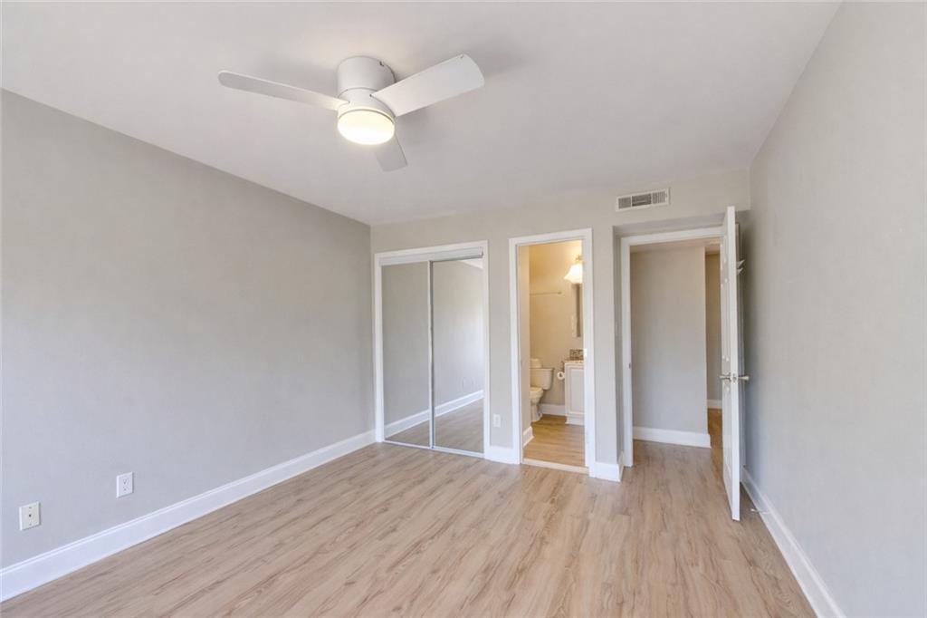 6980 Roswell Road, Unit C5 Atlanta, GA 30328 - Photo 15 of 22 an empty room with wooden floor and ceiling fan