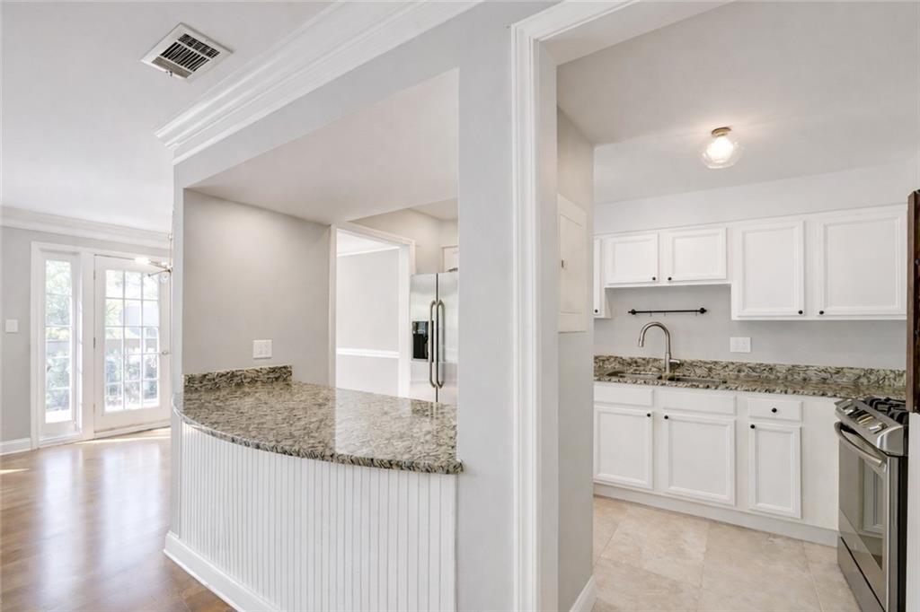 6980 Roswell Road, Unit C5 Atlanta, GA 30328 - Photo 6 of 22 a kitchen with granite countertop a sink and cabinets