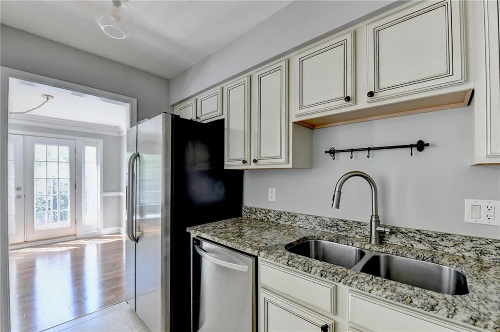 6980 Roswell Road, Unit C5 Atlanta, GA 30328 - Photo 8 of 22 a kitchen with stainless steel appliances granite countertop a refrigerator and a sink