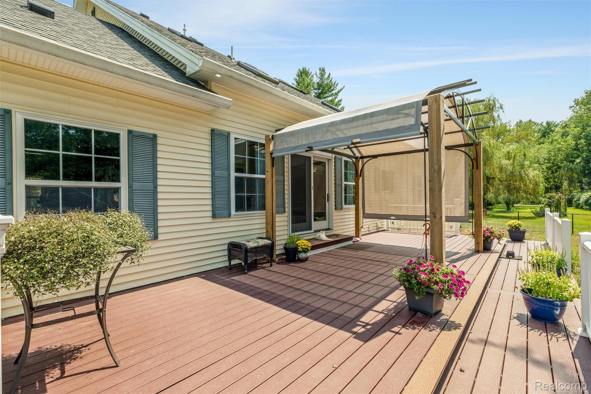 21280 Merriman Road New Boston, MI 48164 - Photo 54 of 65 Expansive multi-level composite deck with a pergola and retractable shade