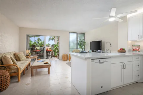 a living room with furniture a flat screen tv and a large window