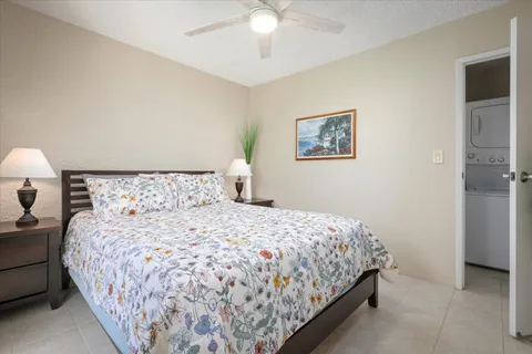a bedroom with a large bed and a chandelier