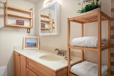 a bathroom with a toilet sink and mirror