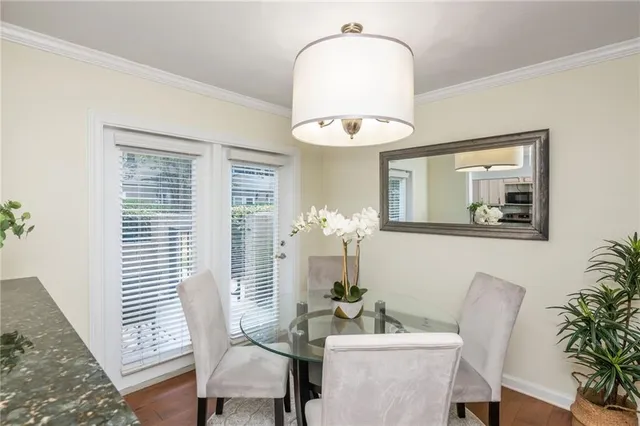 a view of a dining room with furniture and a potted plant
