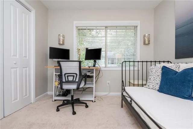 a view of a workspace with furniture and a window