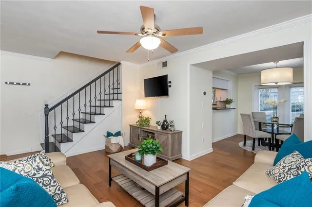 a living room with furniture chandelier and a flat screen tv