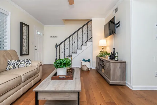 a living room with furniture and wooden floor