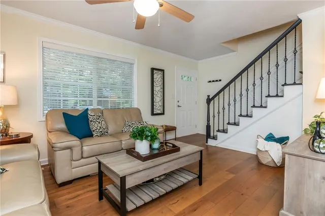 a living room with furniture and wooden floor