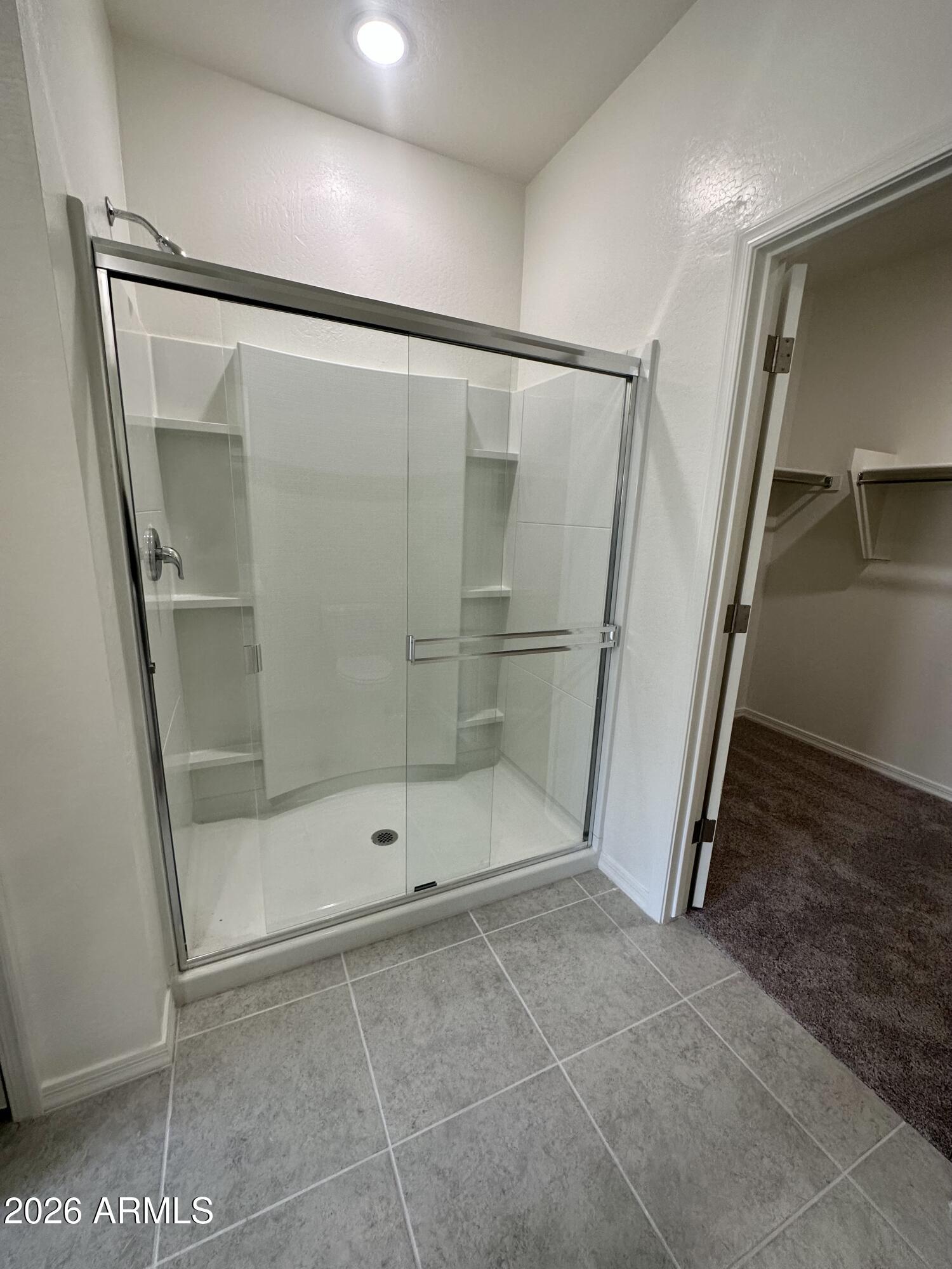 25767 North Boreas Road Florence, AZ 85132 - Photo 7 of 12 a bathroom with a glass door shower