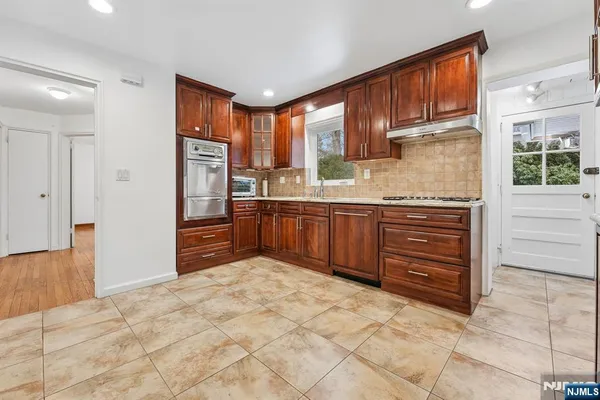 a kitchen with stainless steel appliances granite countertop a refrigerator and cabinets