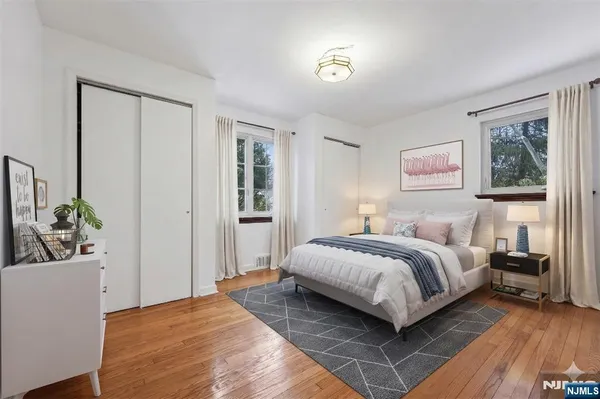 a bedroom with a bed and a potted plant