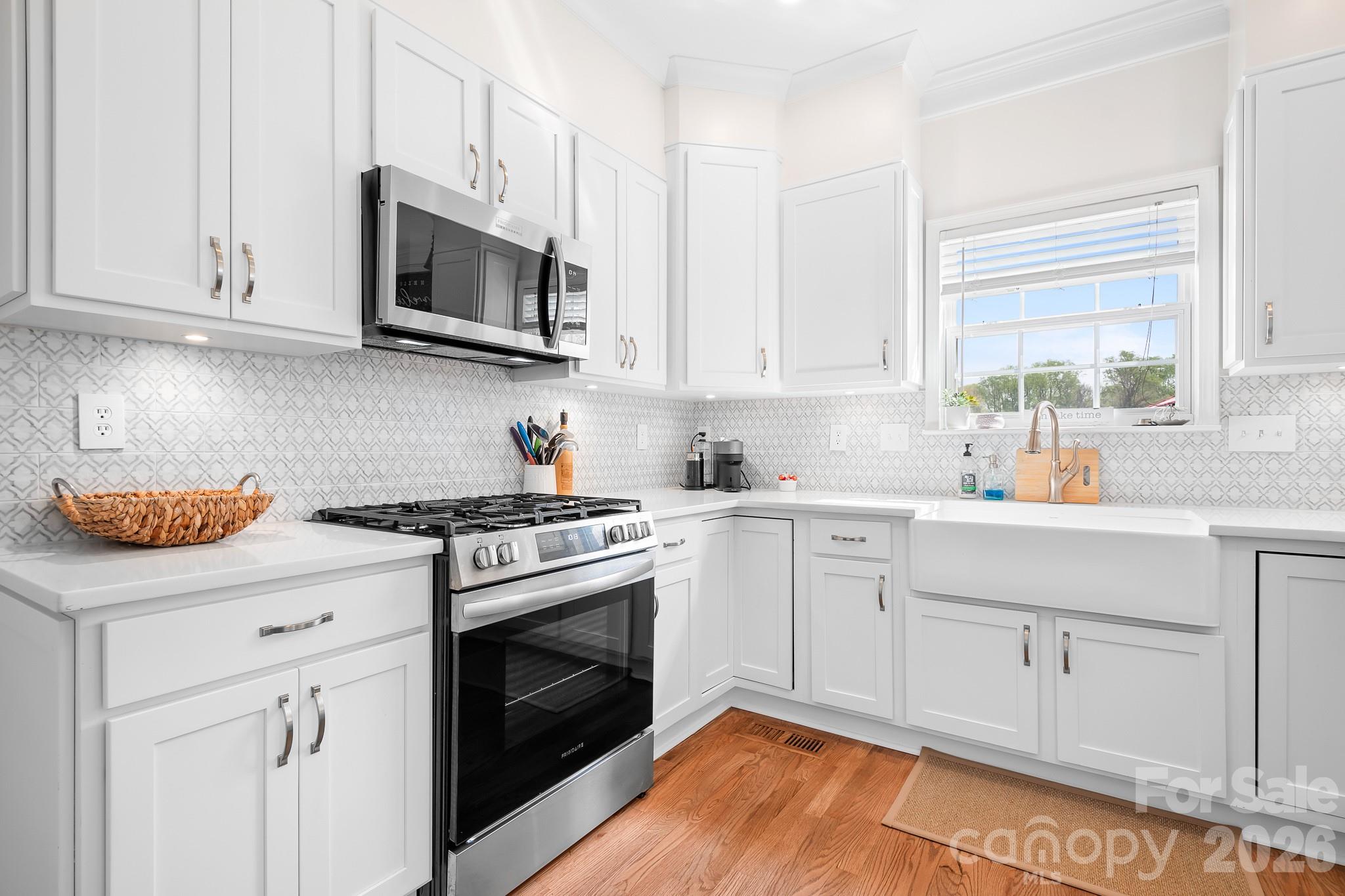220 Chandeleur Drive Mooresville, NC 28117 - Photo 14 of 38 a kitchen with stainless steel appliances granite countertop a sink a stove and microwave