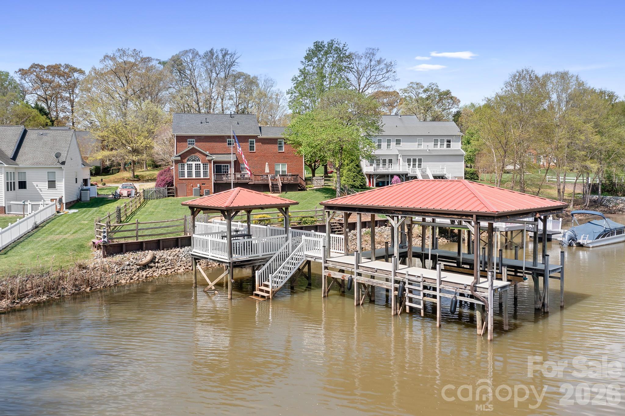 220 Chandeleur Drive Mooresville, NC 28117 - Photo 29 of 38 a view of a lake with a house swimming pool and outdoor space