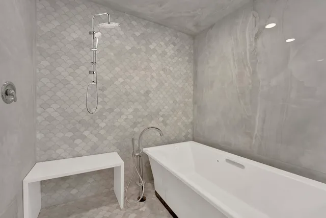 a bathroom with a bathtub and shower