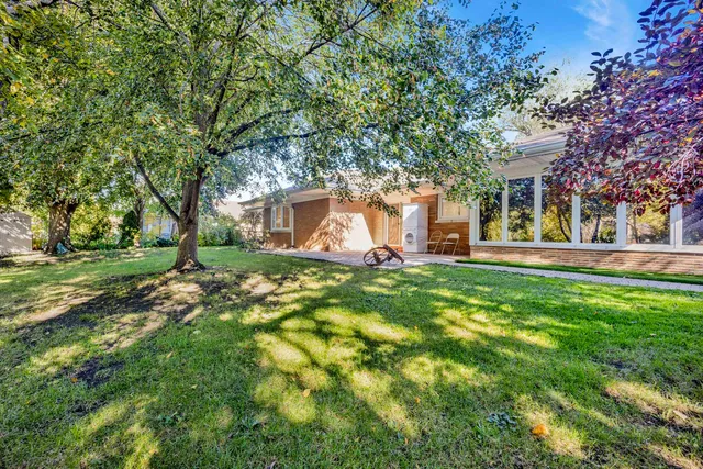 a view of a house with a backyard