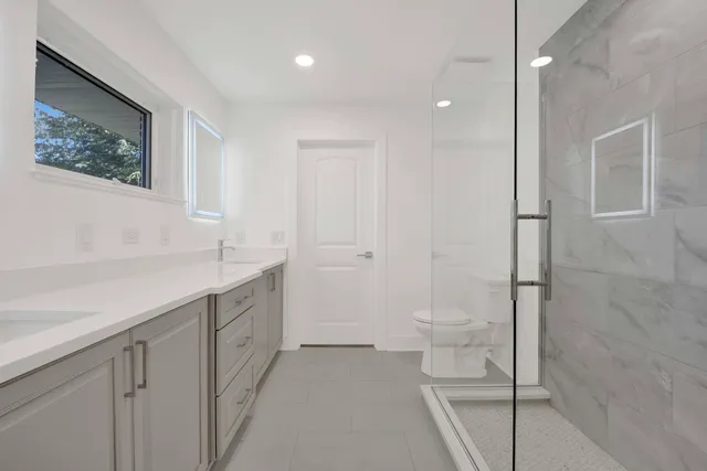 a bathroom with a toilet sink and shower