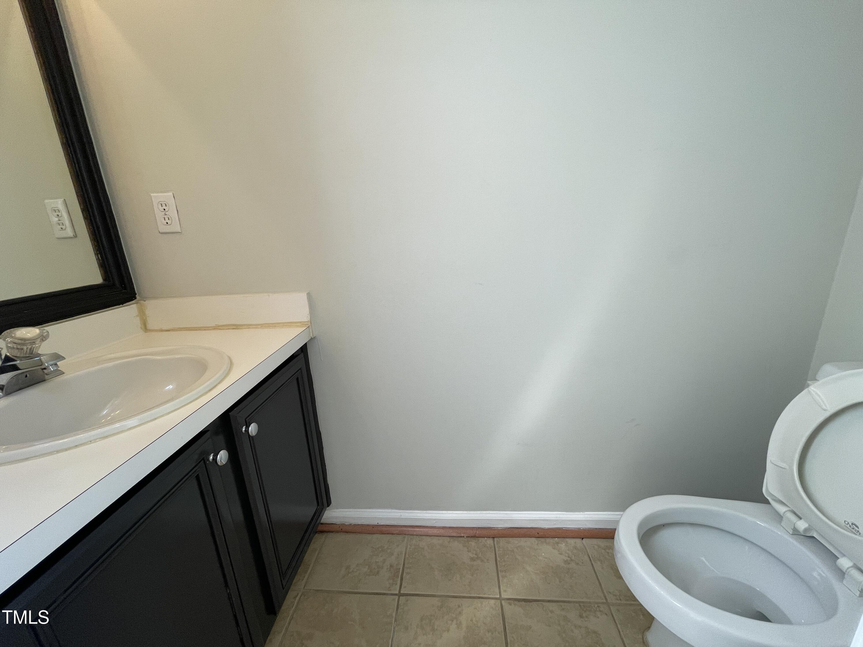 300 Firefly Road Holly Springs, NC 27540 - Photo 14 of 23 a bathroom with a sink and a toilet