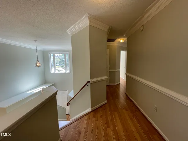 a view of entryway and hall with wooden floor