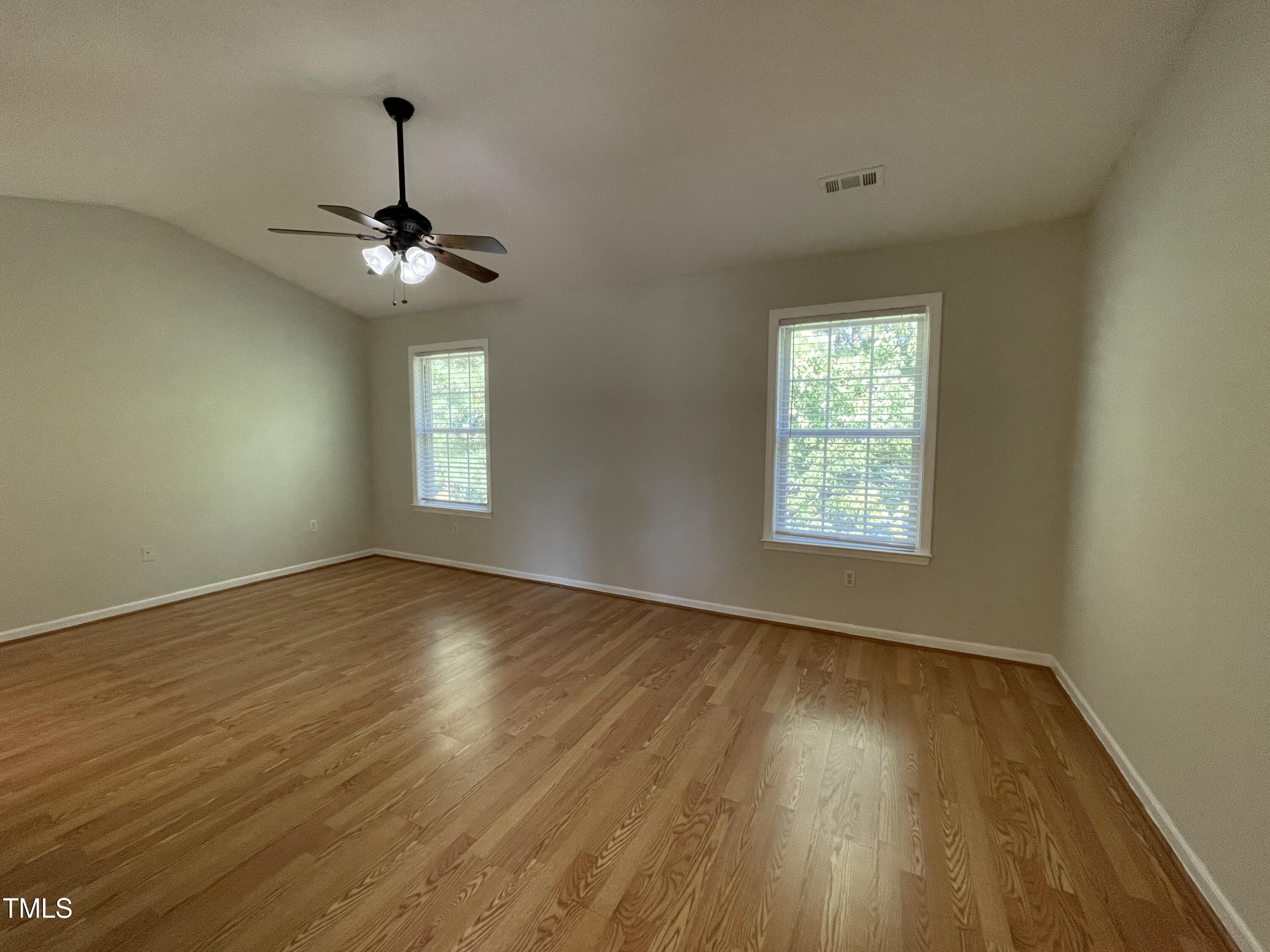 300 Firefly Road Holly Springs, NC 27540 - Photo 17 of 23 wooden floor in an empty room with a window