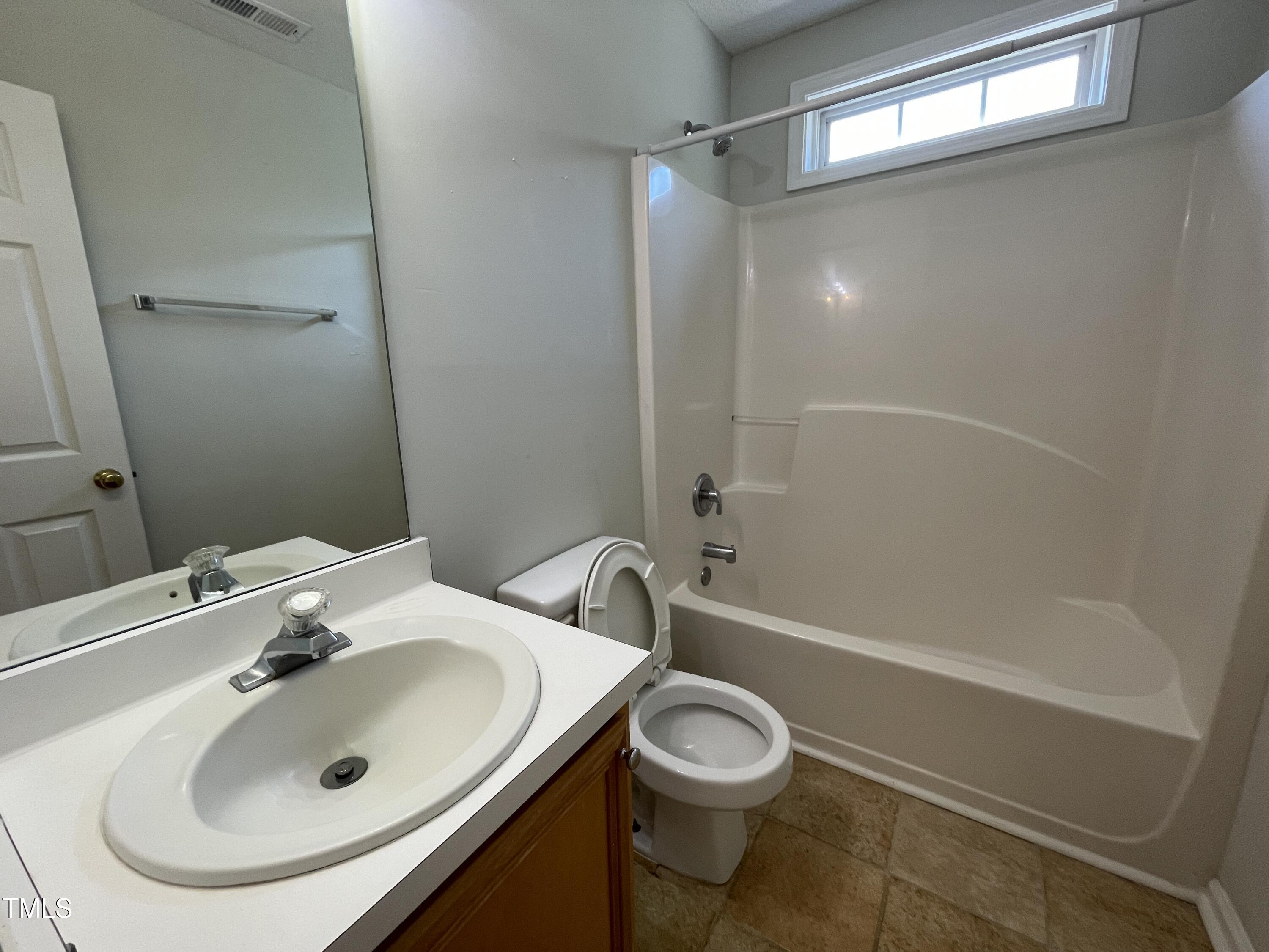 300 Firefly Road Holly Springs, NC 27540 - Photo 21 of 23 a bathroom with a sink a toilet and shower
