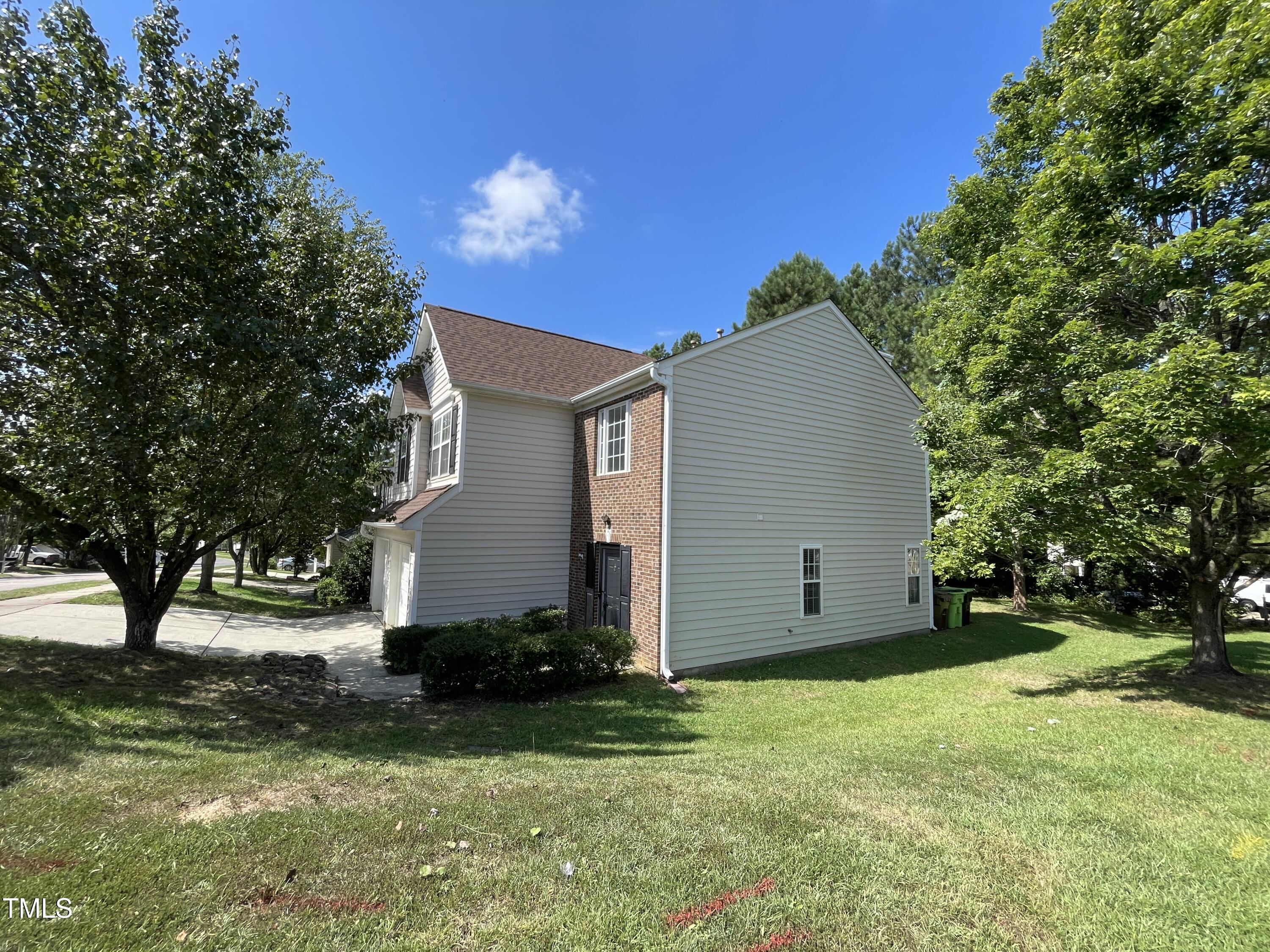 300 Firefly Road Holly Springs, NC 27540 - Photo 3 of 23 a view of a backyard with potted plants and large trees