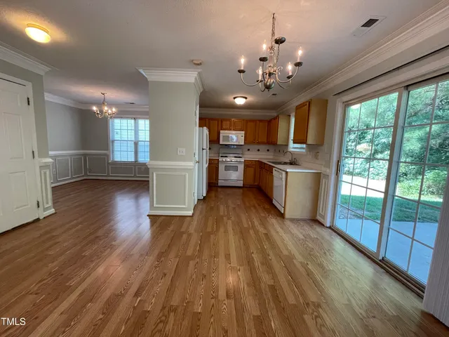 a open kitchen with stainless steel appliances granite countertop a stove top oven and refrigerator