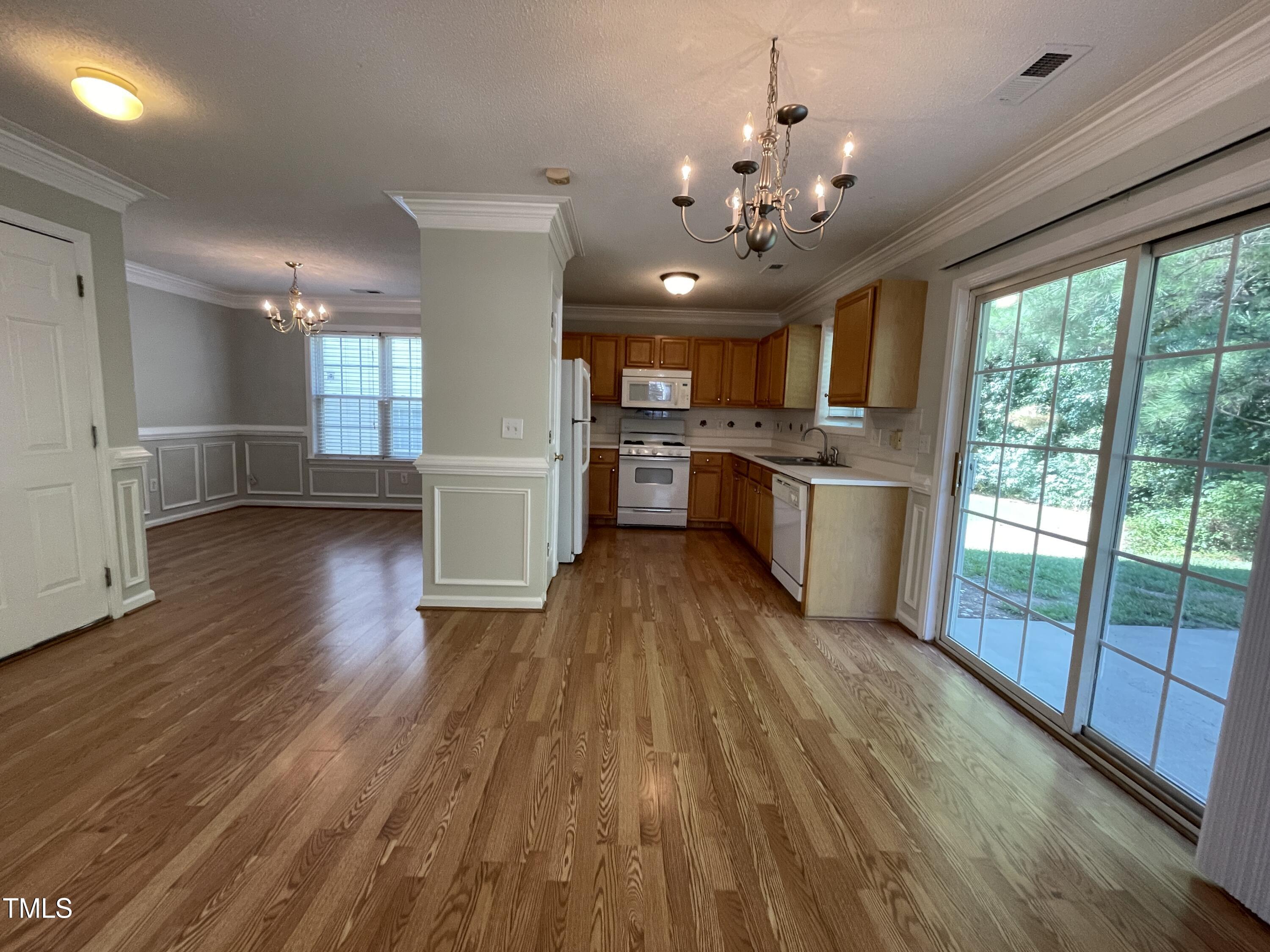 300 Firefly Road Holly Springs, NC 27540 - Photo 9 of 23 a open kitchen with stainless steel appliances granite countertop a stove top oven and refrigerator