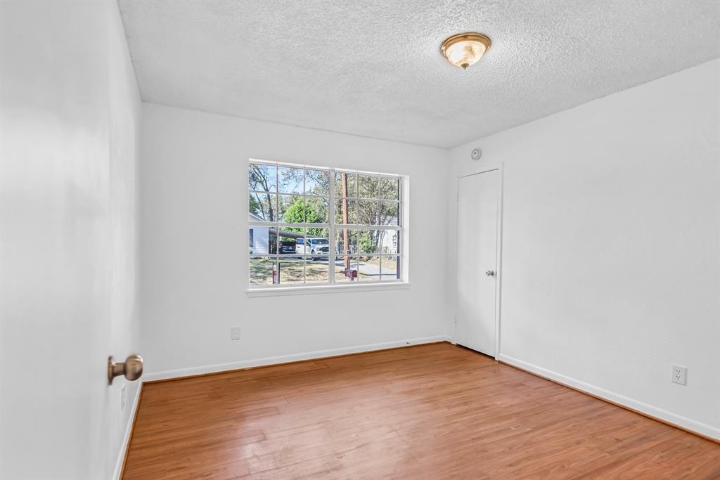 815 North Bledsoe Street Gilmer, TX 75644 - Photo 13 of 25 an empty room with a window