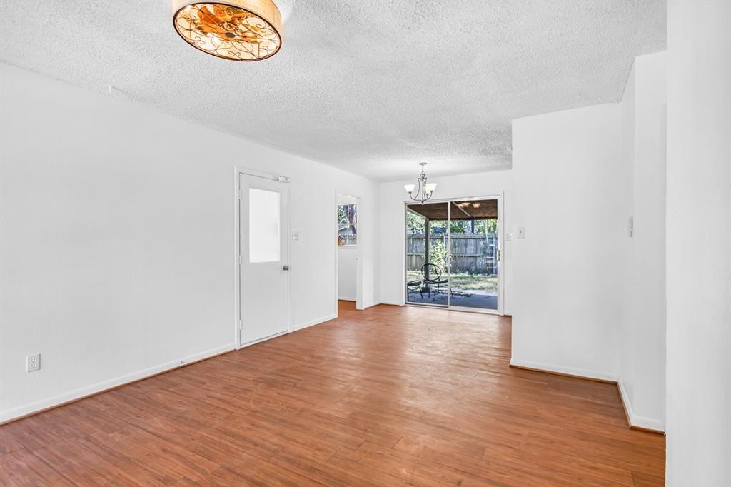 815 North Bledsoe Street Gilmer, TX 75644 - Photo 14 of 25 an empty room with wooden floor and window