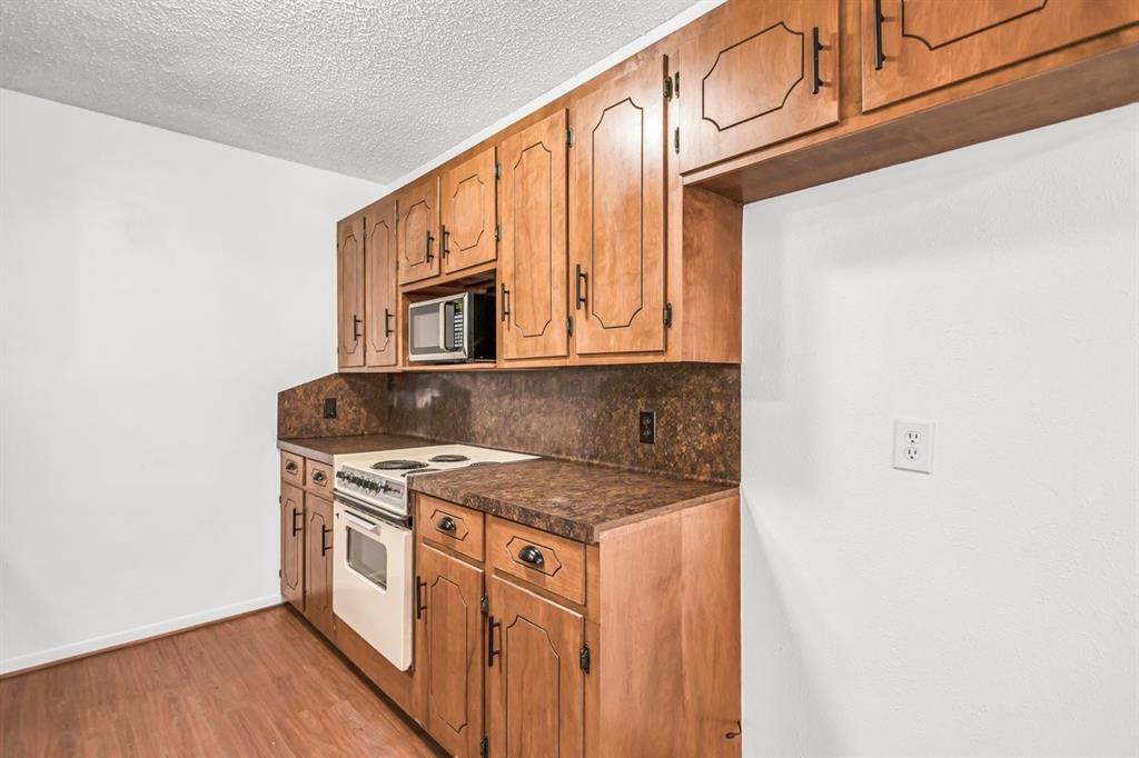 815 North Bledsoe Street Gilmer, TX 75644 - Photo 7 of 25 a kitchen with stainless steel appliances granite countertop a sink and cabinets
