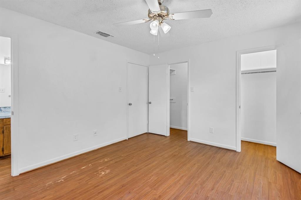 815 North Bledsoe Street Gilmer, TX 75644 - Photo 10 of 25 an empty room with wooden floor closet and windows