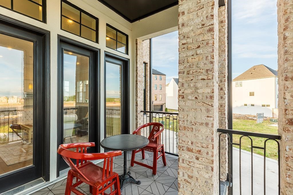9546 London Bridge Station Houston, TX 77045 - Photo 27 of 41 Step into your private oasis with a balcony that captures the charm of a secluded cafe, offering a perfect vantage point to the vibrant world beyond.