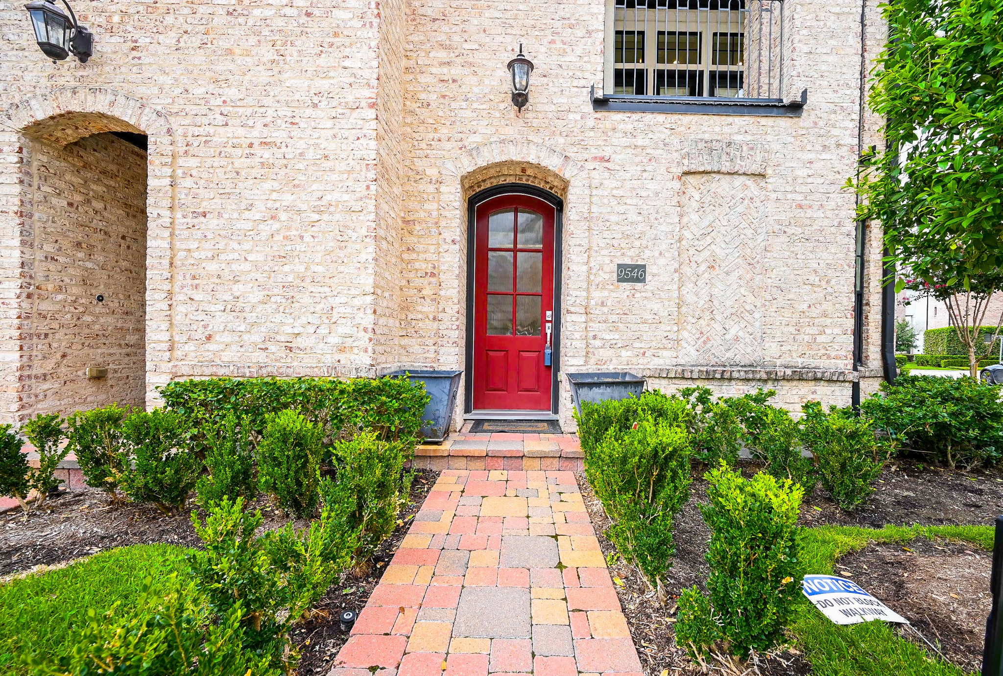 9546 London Bridge Station Houston, TX 77045 - Photo 5 of 41 Discover a charming European-style retreat with a practical covered front entry, featuring an artisan-inspired brick and stone facade and a vibrant tiled walkway that enhances its visual appeal.