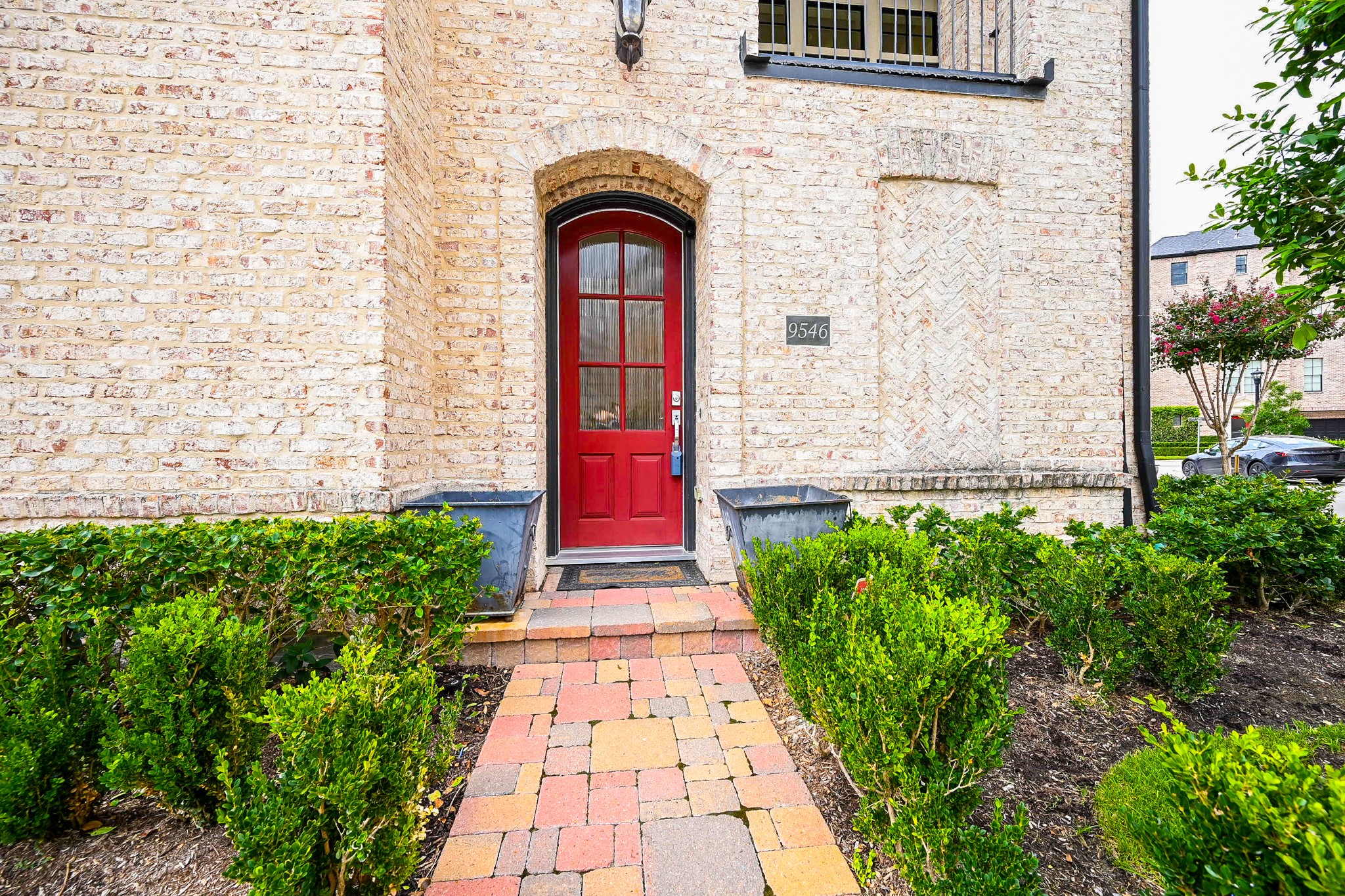9546 London Bridge Station Houston, TX 77045 - Photo 6 of 41 This home's inviting European-style cottage entry combines practicality and charm with its artisan brick and stone facade and a vibrant tiled walkway.