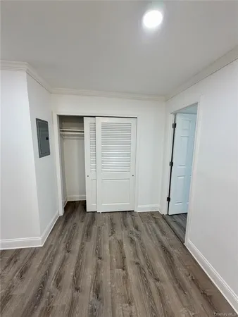 an empty room with wooden floor and closet