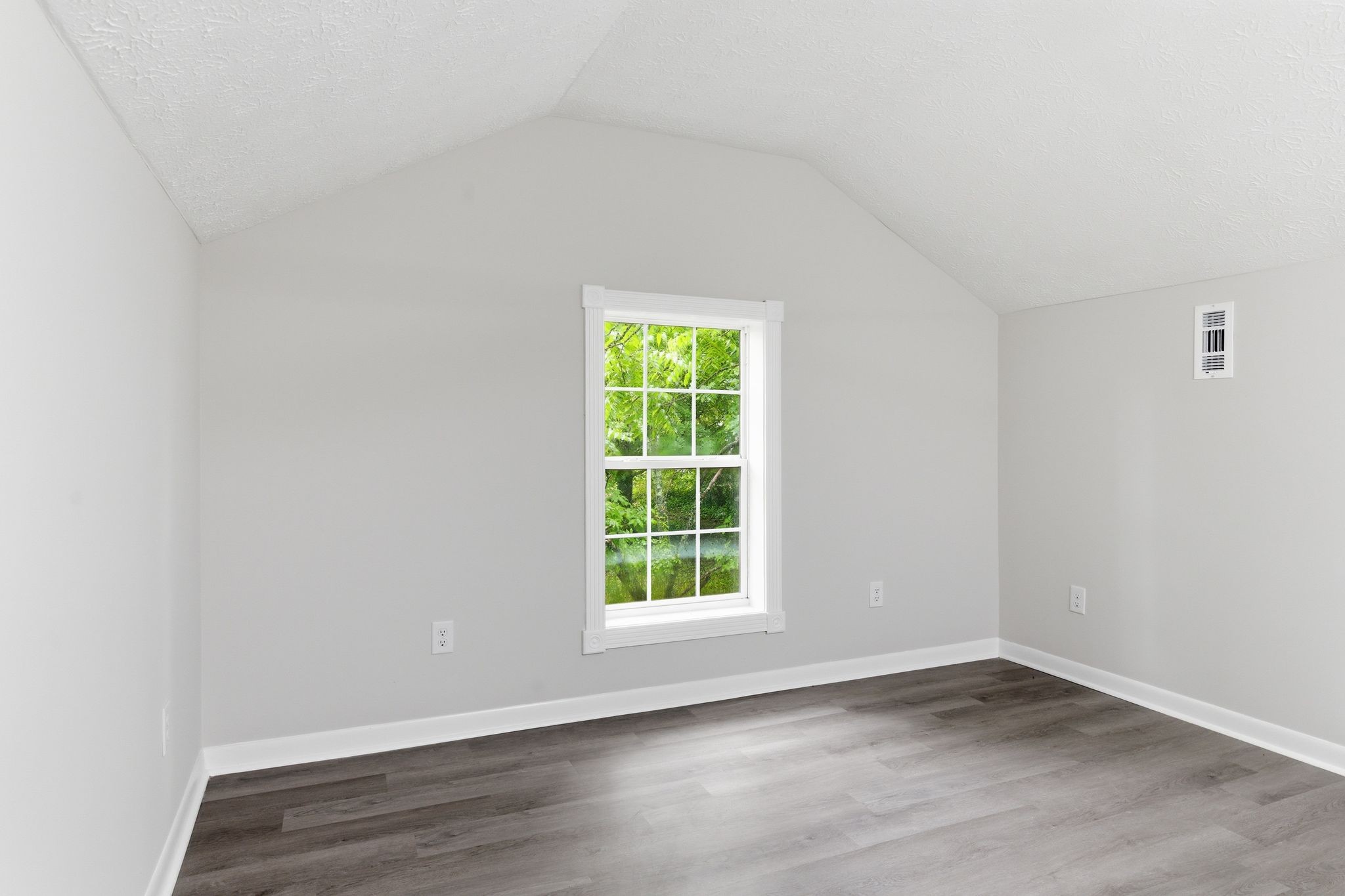 305 South Irwin Street Manchester, TN 37355 - Photo 28 of 40 a view of an empty room with wooden floor and a window