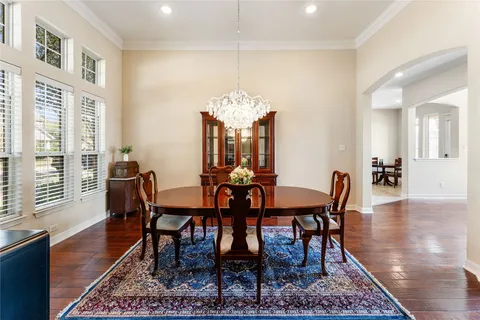 a view of a a dining room with furniture window and wooden floor