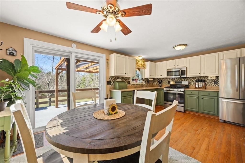 500 Wareham Street Middleboro, MA 02346 - Photo 13 of 42 a kitchen with stainless steel appliances granite countertop a stove a refrigerator a oven a dining table and chairs with wooden floor