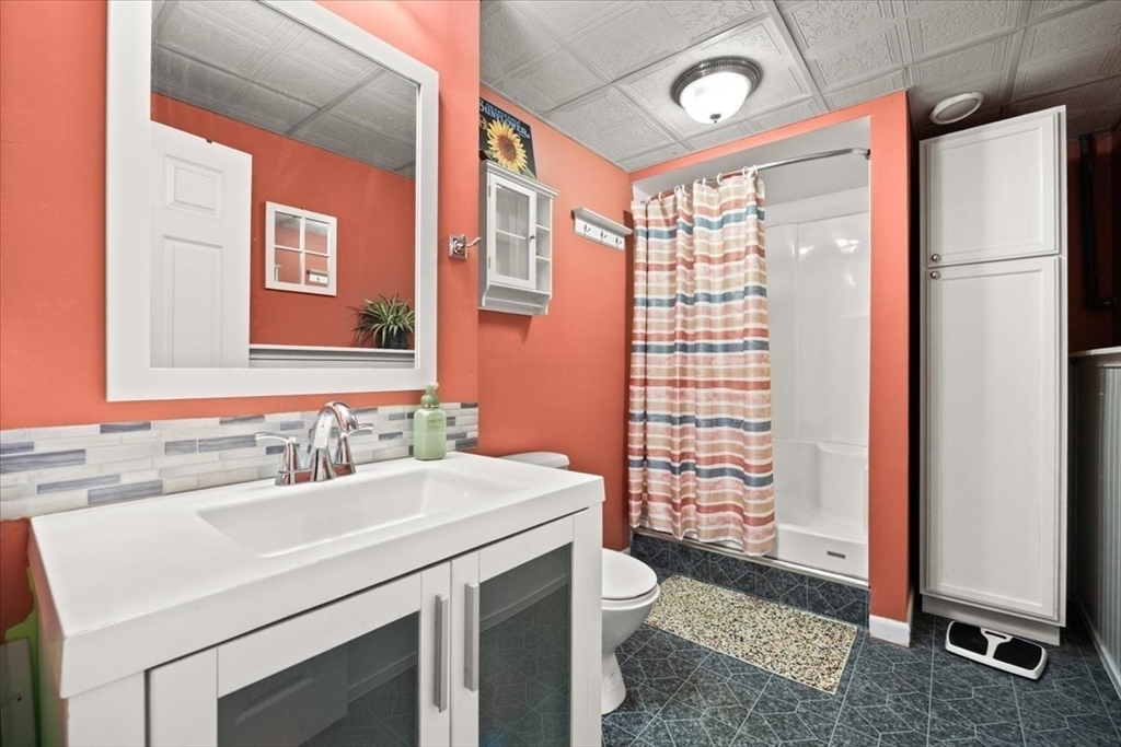 500 Wareham Street Middleboro, MA 02346 - Photo 34 of 42 a bathroom with a sink a toilet a mirror and shower