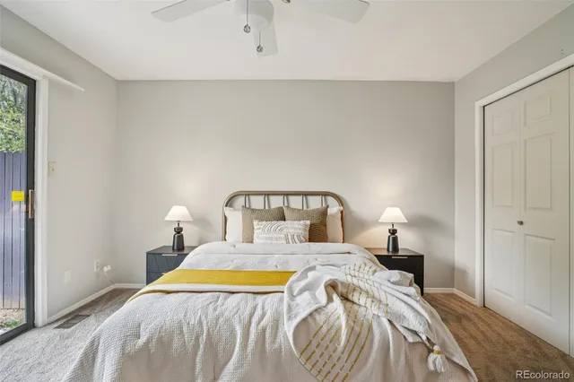 a bedroom with a bed and painting on the wall