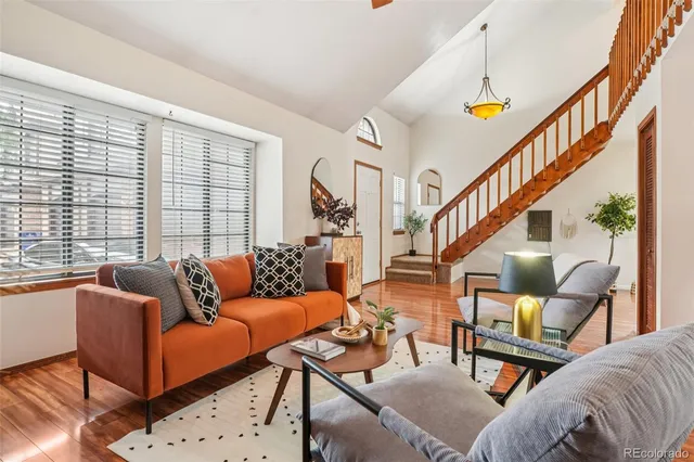 a living room filled with furniture hardwood floor and a chandelier