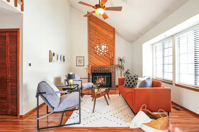 a view of a dining room with furniture large windows and wooden floor