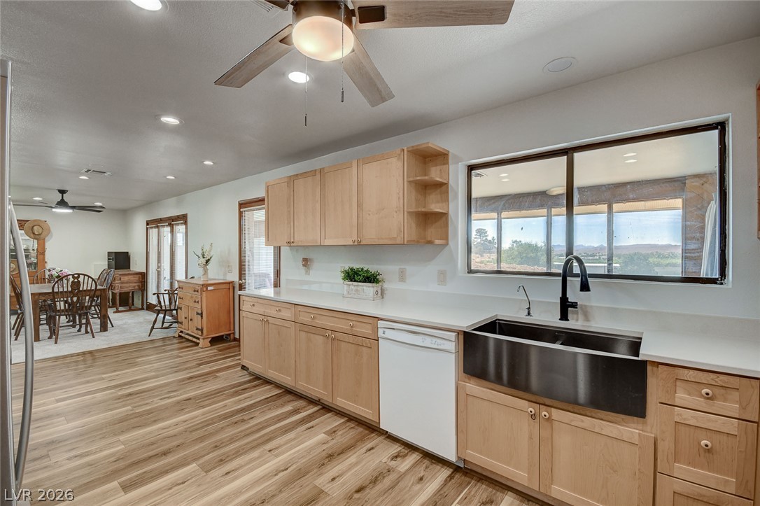 1920 Bowman Road Logandale, NV 89021 - Photo 27 of 68 Warm wood cabinetry and durable flooring frame a functional workspace overlooking the property.