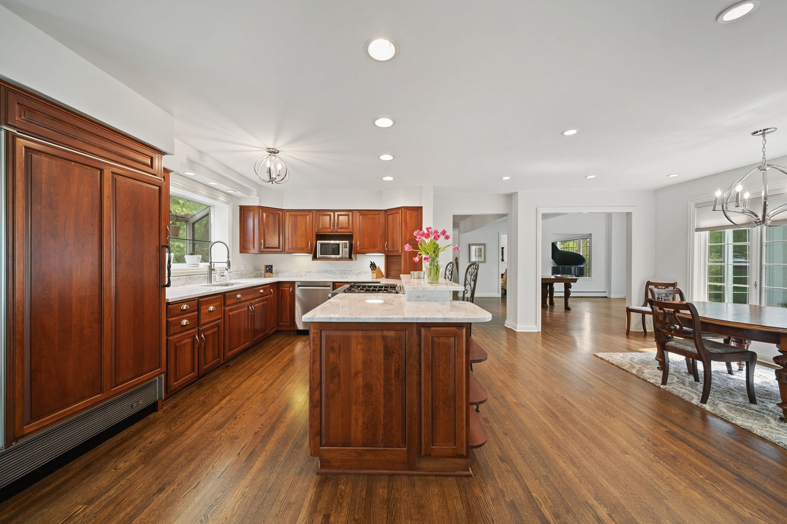 7-n751 Sayer Road Bartlett, IL 60103 - Photo 14 of 30 a large kitchen with stainless steel appliances refrigerator dining table and chairs