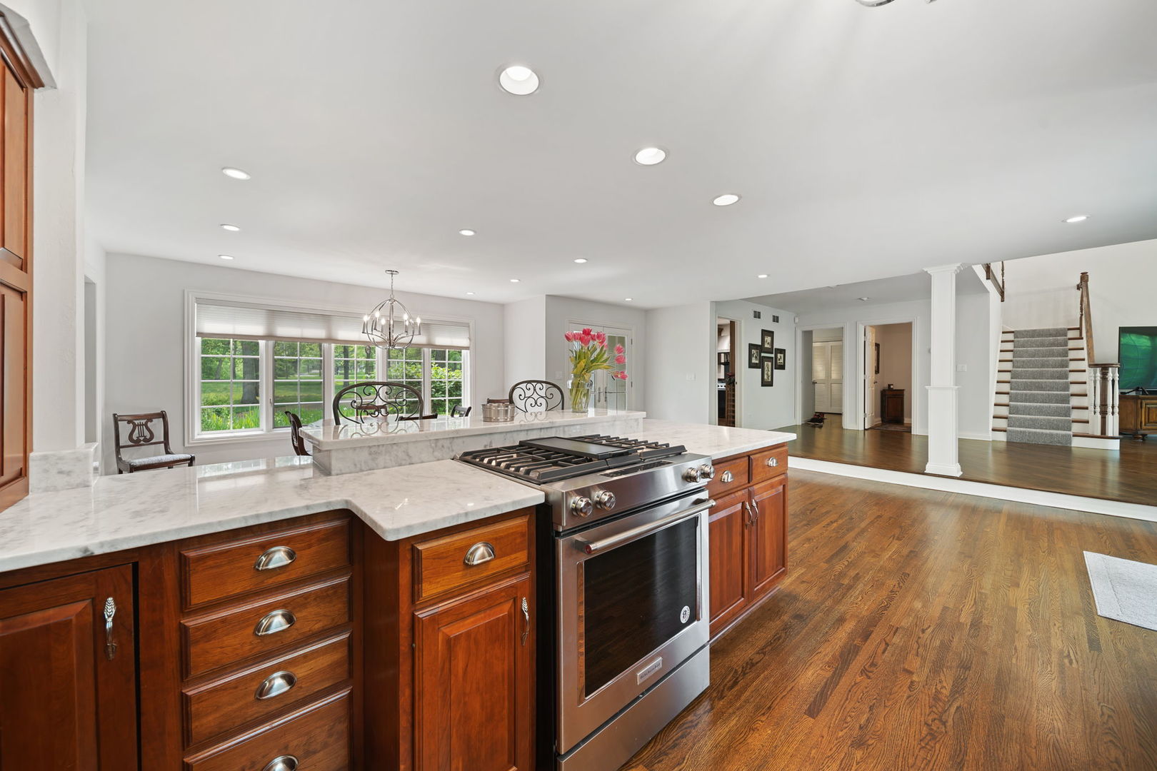 7-n751 Sayer Road Bartlett, IL 60103 - Photo 17 of 30 a kitchen with stainless steel appliances granite countertop wooden floor sink stove and wooden cabinets