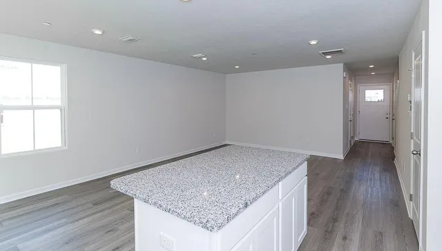 a white toilet sitting next to a window