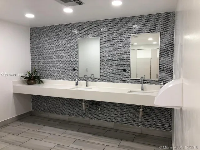 a view of a house with a yard and potted plants